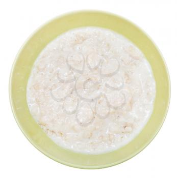 top view of traditional english oat porridge with milk in ceramic bowl isolated on white background