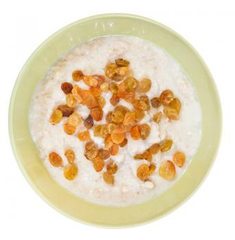 top view of traditional english oat porridge with raisins in yellow bowl isolated on white background
