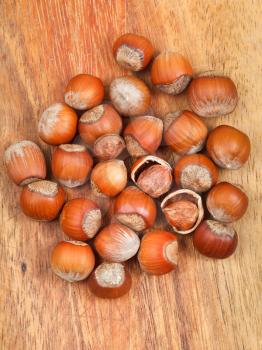 handful of hazelnuts on wooden board