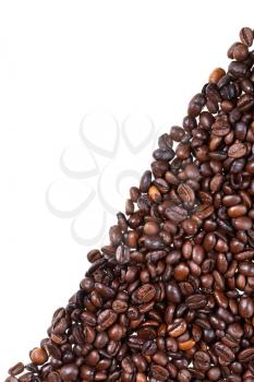 slope from dark roasted coffee beans close up on white background