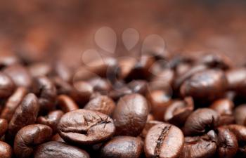 roasted coffee beans background with focus foreground