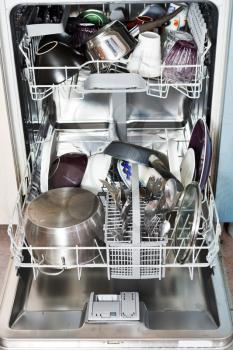 dirty cookware in open kitchen dishwasher
