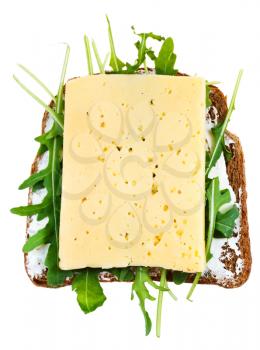 top view of rye bread, cheese and fresh arugula sandwich isolated on white background