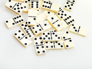above view of scattered dominoes on white background