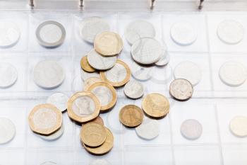 page of numismatics album with different coins