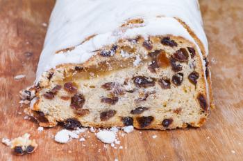 Stollen cake with dried fruits and marzipan and covered with powdered sugar