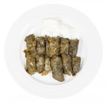 above view of portion caucasus meal - dolma from vine leaves and mince on plate isolated on white background
