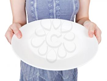 woman holds empty white plate isolated on white background