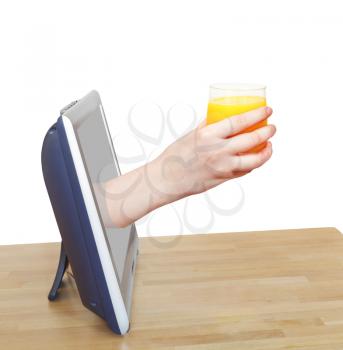 glass with fresh orange juice in hand leans out TV screen isolated on white background
