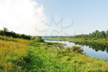green riverside of small river in summer day, Russia