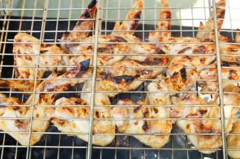 grilled chicken wings on barbecue close up