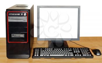 black computer, display with cutout screen, keyboard, mouse on wood table isolated on white background