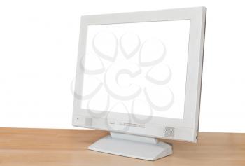 side view of grey computer display with cutout screen on wood table isolated on white background