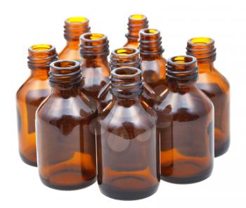 many small open amber glass oval pharmacy bottles isolated on white background