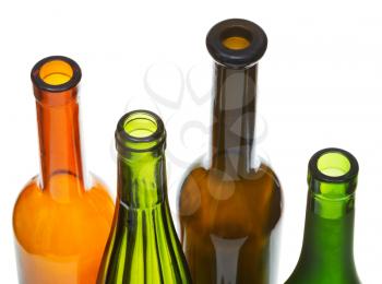 four open bottlenecks of colored wine bottles close up isolated on white background