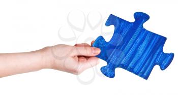 female hand with painted blue puzzle piece isolated on white background