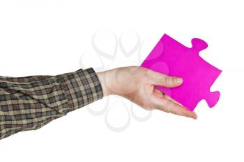 male hand holding big pink paper puzzle piece isolated on white background