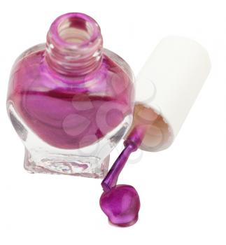 bottle and spilled violet nail polish isolated on white background