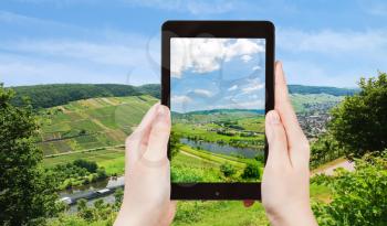 travel concept - tourist taking photo of Moselle valley and Mosel river in summer day, Germany on mobile gadget