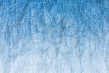 blue and white dyeing of denim jean - textile background close up