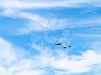 air refueling of military fighter aircrafts in white clouds in blue sky