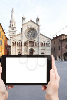 travel concept - tourist photograph Corso Duomo and facade of Modena Cathedral, Italy on tablet pc with cut out screen with blank place for advertising logo