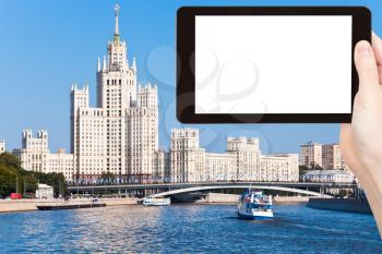 travel concept - tourist photograph Moscow cityscape with Stalin's high-rise building on kotelnicheskaya embankment on tablet pc with cut out screen with blank place for advertising logo