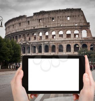 travel concept - tourist photograph Coliseum in Rome, Italy in autumn dayon tablet pc with cut out screen with blank place for advertising logo