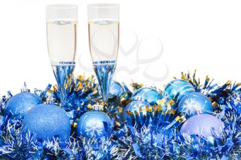 two glasses of champagne at blue Christmas decorations isolated on white background