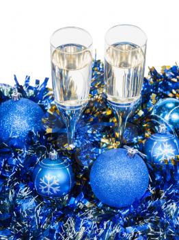 above view of two glasses of champagne at blue Christmas decorations isolated on white background