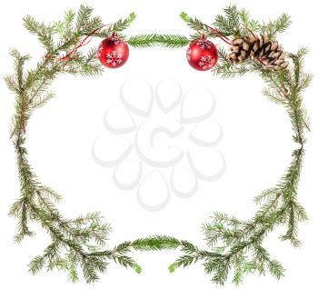 christmas greeting card frame - fir tree twigs with cones and red balls on white background