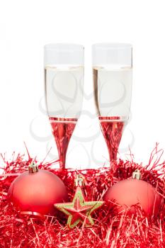 two glasses of champagne and star at red Christmas decorations isolated on white background