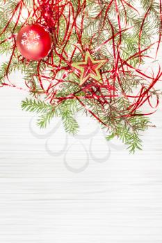 Christmas greeting card - border from star and red Xmas ball and tree branch on blank paper background