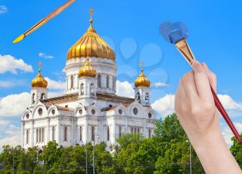 travel concept - hand paints by painbrush blue sky over russian cathedral