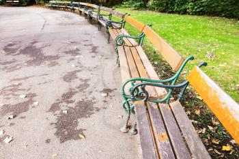 travel to Vienna city - empty wooden benches in Stadtpark (City Park) Vienna in autumn morning