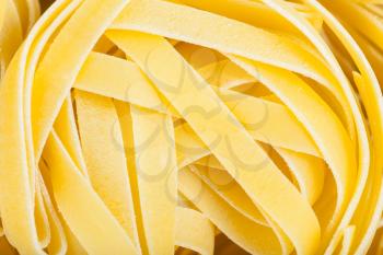 food background - durum wheat semolina pasta fettuccine close up