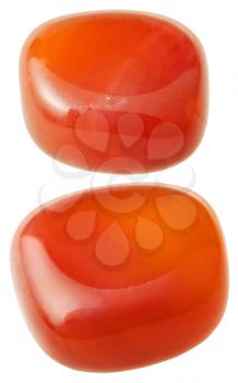 natural mineral gem stone - two carnelian (cornelian, sard) gemstones isolated on white background close up