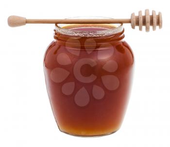side view glass jar with brown honey and wooden stick isolated on white background