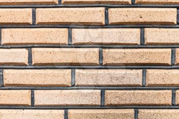 textured background - rows of yellow bricks in wall