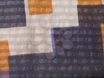 textile background - silk fabric with geometric pattern with crape jacquard weave pattern of threads close up