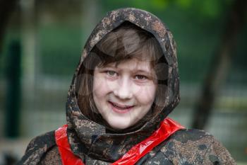 smiling girl in camouflage before playing paintball