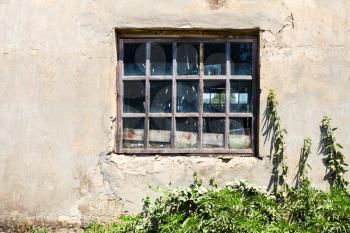 window in old shabby building in sunny summer day