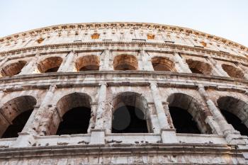 travel to Italy - wall of ancient roman amphitheater Coliseum in Rome city in evening