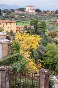 travel to Italy - above view of green and yellow Florence neighborhood from San Miniato al Monte in autumn