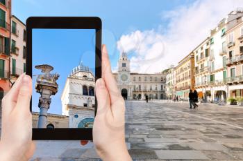 travel concept - tourist photographs column Marciana on piazza dei Signori in Padua city on tablet in Italy