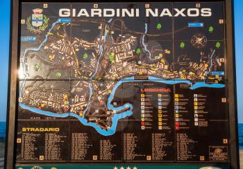 GIARDINI NAXOS, ITALY - JULY 6, 2011: city map of Giardini Naxos town on urban beach in evening. Naxos was founded by Thucles the Chalcidian in 734 BC, and since 1970s it has become a seaside-resort