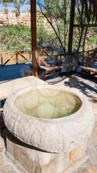 Travel to Middle East country Kingdom of Jordan - ancient Baptismal font of Baptism Site Bethany Beyond the Jordan (Al-Maghtas) on the east bank of the Jordan River in winter