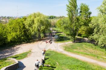 KIEV, UKRAINE - MAY 5, 2017: people in urban public park on Gonchary-Kozhemyaki tract in Kiev city near Landscape alley in spring. The alley passes through the defensive shaft of Kiev of the 10th cent