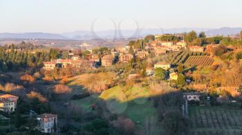 travel to Italy - country houses and gardens in Siena city on hills in winter evening