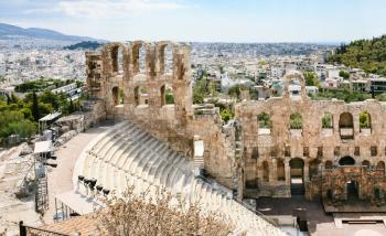 travel to Greece - view of Odeon of Herodes Atticus stone theatre at Acropolis and Athens city